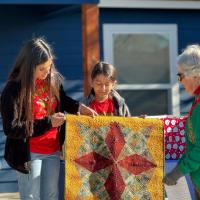 Carol Pope gifting a quilt