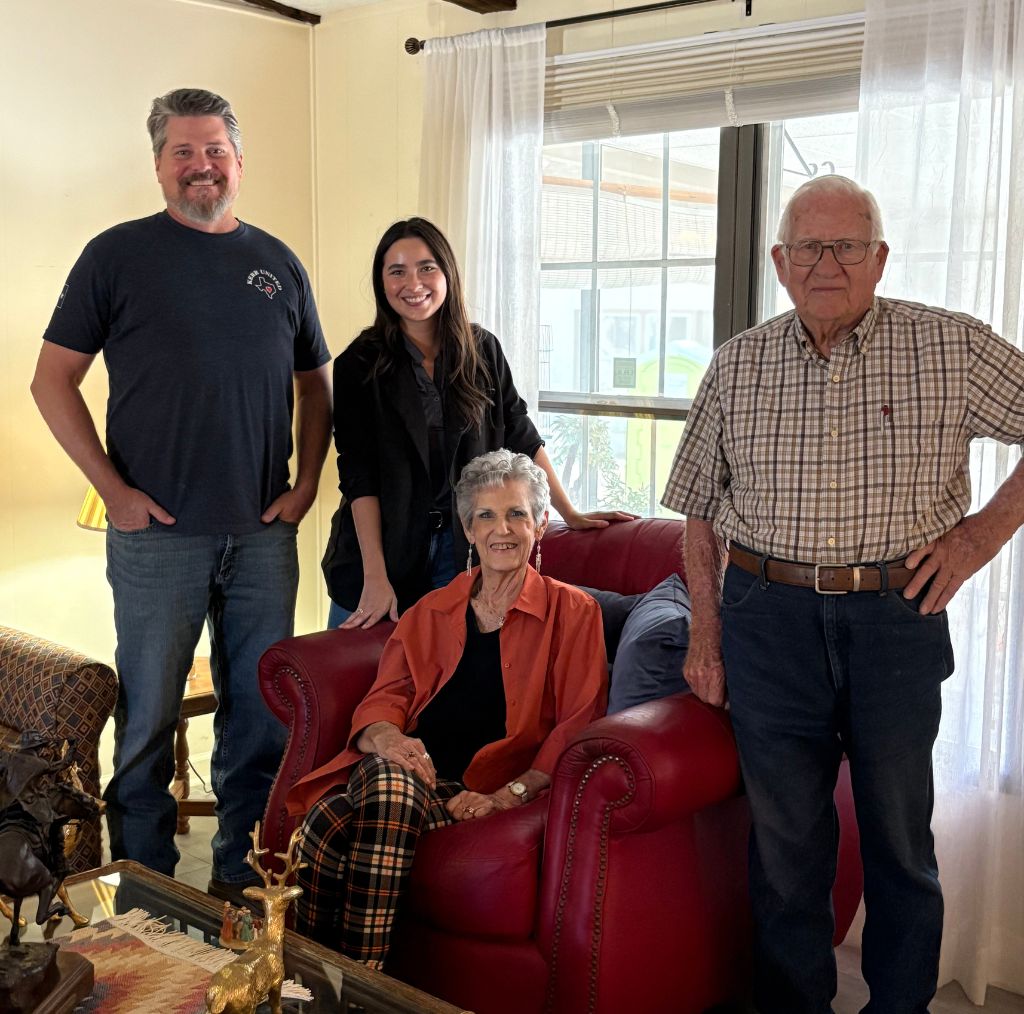 Four people sitting in Living Room posing for a picture